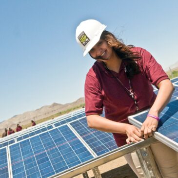 Woman installing solar panels